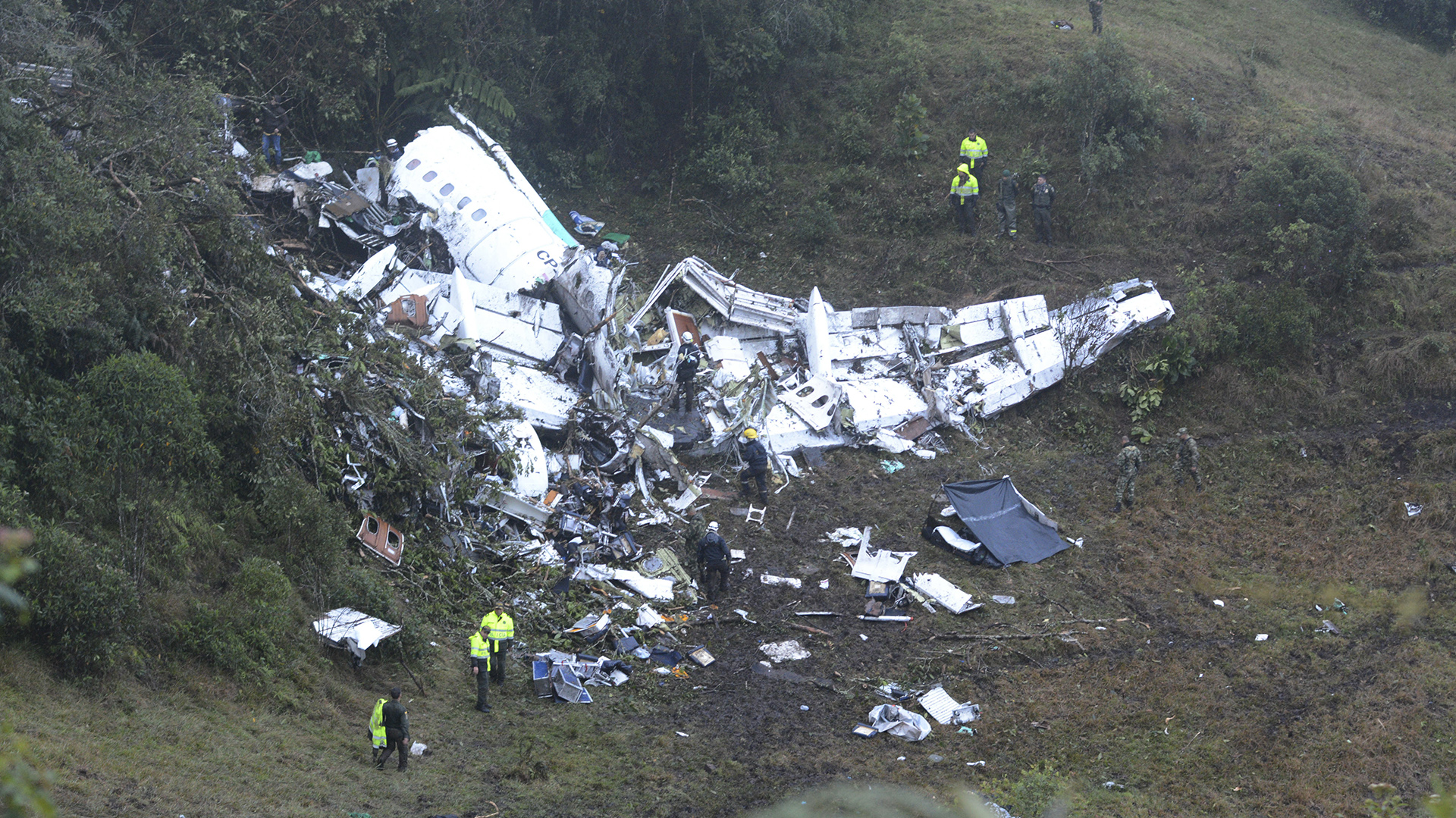Police officers and rescue workers search for survivors around the wreckage of a chartered airplane that crashed in La Union, a mountainous area outside Medellin, Colombia, Wednesday , Nov. 30, 2016. The plane was carrying the Brazilian first division soccer club Chapecoense team that was on it's way for a Copa Sudamericana final match against Colombia's Atletico Nacional. (AP Photo/Luis Benavides)